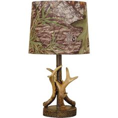 a lamp with deer antlers on it and a camo shade over the base