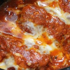 a slow cooker filled with meatballs and cheese on top of it's surface