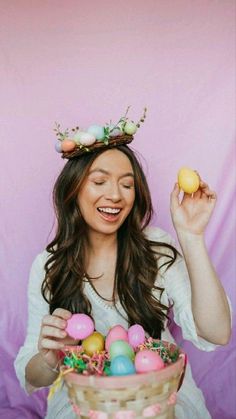 a woman wearing a crown holding an egg