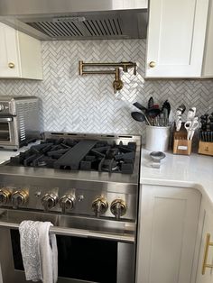 a stove top oven sitting inside of a kitchen