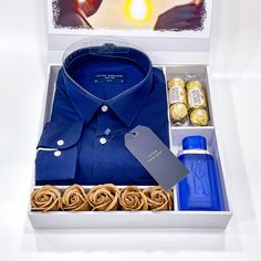 a blue shirt and some chocolates in a box