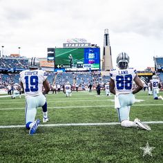 two football players sitting on the field during a game