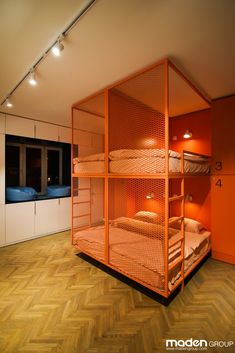 a room with bunk beds and orange walls