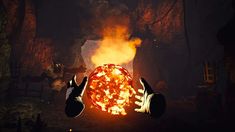 two hands holding up a fireball in the dark