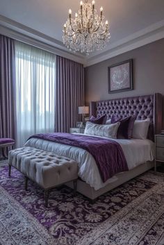 a bedroom with a purple bed and chandelier