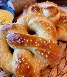 several pretzels on a plate with dipping sauce