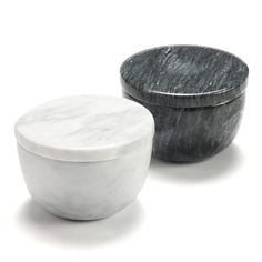 two marble bowls sitting next to each other