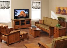 a living room filled with furniture and a flat screen tv on top of a wooden table