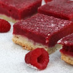 a piece of cake and a strawberry on a white plate with the rest of the cake