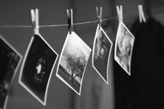 black and white photo hanging on clothes line with pictures hung to dry in the sun