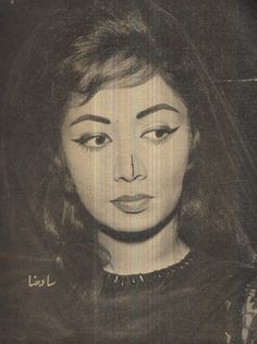 an old black and white photo of a woman's face with eyes wide open