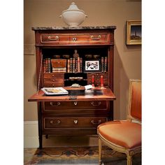 an old fashioned desk and chair in a room