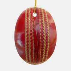 a close up of a red cricket ball on a white background