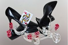 a pair of black high heels with red and white dice on them