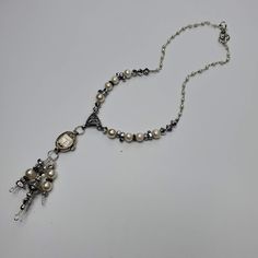 "This necklace has a vintage (non-working) Elgin watch marked 10K RGP. The watch is strung with pearl, silver, hematite and crystal beads which also dangle from the watch. The silver tone chain is dotted with faux pearls to complete the look. Given the age of the components, there will be scratches and scuffs on the watches and crystals, but I think that just adds to the vintage look...a real stunner! This necklace is 17\" long. The pendent portion is 3.5\". These necklaces make a statement and Vintage Soldered Dangle Jewelry, Vintage Pearl Jewelry With Beaded Chain, Silver Beaded Dangle Pearl Necklace, Silver Metal Pearl Necklace With Beaded Chain, Bohemian Silver Pendant Pearl Necklace, Silver Bohemian Pearl Drop Necklace, Bohemian Silver Pearl Pendant Necklace, Formal Silver Jewelry With Beaded Chain, Silver Beaded Chain Jewelry For Formal Occasions