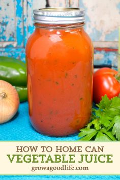 a jar filled with homemade vegetable juice next to fresh vegetables