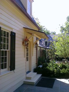 a white house with black shutters and windows