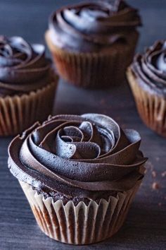 chocolate cupcakes with frosting on a table