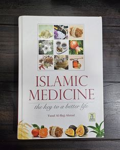 a book on islamic medicine sitting on top of a wooden table