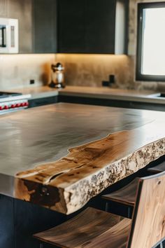 a wooden table sitting in front of a tv on top of a kitchen countertop