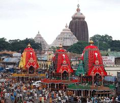 a large group of people standing around colorfully decorated buildings