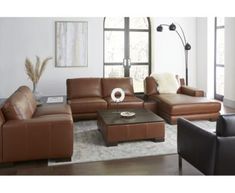 a living room filled with lots of brown furniture