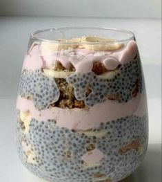 a close up of a dessert in a glass on a white table with blue dots