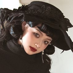 An elegant hat with a wide, drooping brim that gives it the look of a seductive black magician. The design decorated with feathers has a heretical atmosphere. Try wearing black to create a mysterious charm. 
 
 
 Size 
 
 FREE size 
 
 Head circumference: 56-58cm 
 Brim: 15cm 
 Depth: 8.2cm 
 
 
 
 
 Material 
 
 Wool Gothic Winter Costume Hats And Headpieces, Vintage Black Mini Hat For Cosplay, Elegant Black Costume Hat, Elegant Black Hat For Costume, Black Fedora Halloween Costume Hat, Black Fedora For Halloween, Elegant Winter Costume Hats And Headpieces, Elegant Black Halloween Costume Hats And Headpieces, Elegant Black Halloween Hats