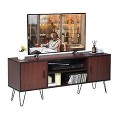 an entertainment center with a television on top of it and two hairpin legs in front of the tv