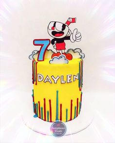 a birthday cake with an image of mickey mouse on the top and number seven on the bottom