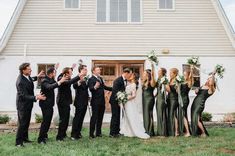 a group of people standing in front of a house