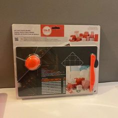 an orange object is on display in the box for people to see it's contents