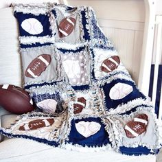 a blanket with footballs and hearts on it is sitting next to a crib