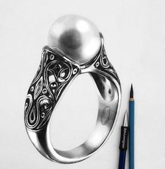 a drawing of a ring with a pearl on it and a pencil next to it