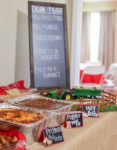 there are many different foods on the table and one has a sign in front of it