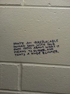 graffiti written on the side of a white brick wall that says, you're an irrebable woman