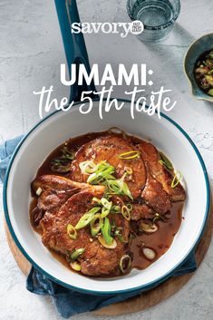 a bowl filled with meat and sauce on top of a table