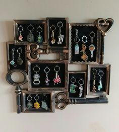 a bunch of key chains are hanging on a wall with pictures and keys in them