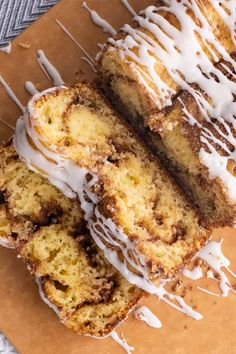 a close up of a cake with icing on a cutting board next to a fork