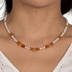 A delicate necklace that combines amber, freshwater pearls and faceted citrine drops with handcrafted design elements in gold-plated sterling silver is a stunning piece of jewelry that exudes elegance and sophistication. Amber, a fossil resin, brings a warm and natural beauty to the design, adding a touch of antiquity. The freshwater pearls add a delicate and feminine touch, while the faceted citrine drops bring a radiant beauty and energy to the design. The handcrafted design elements in gold p Elegant Baltic Amber Jewelry With Natural Stones, Baltic Amber Gemstone Necklaces, Elegant Yellow Baltic Amber Necklaces, Elegant Beaded Citrine Necklaces, Elegant Citrine Beaded Necklaces, Elegant Gold Baltic Amber Necklace, Elegant Orange Pearl Necklace Gift, Orange Pearl Necklace As A Gift, Yellow Pearl Jewelry Gift