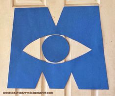 a blue paper cut out of the shape of an eye on top of a door