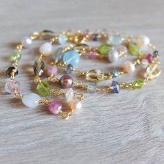 This is  a  pastel color multigemstone  necklace made from all kind of genuine gemstones There is a riot of colors  and shapes in different sizes, I've also added 5-6  mm blush freshwater pearls This necklace features semiprecious gemstones that include  peridot, garnet, iolite, aquamarine,  quartz, citrine, amethyst and  many more!  It is  handwrapped with gold flled  wire and all natural gemstones. It closes with a gold filled ring  clasp The necklace  will be perfect for everyday wear and t i Multicolor Pearl Necklaces With Gemstones, Multicolor Pearl Jewelry With Gemstones, Elegant Multicolor Gemstone Beads Pearl Necklace, Elegant Multicolor Pearl Necklace With Gemstone, Elegant Handmade Pastel Necklaces, Gift Multicolor Pearl Necklace With Gemstones, Elegant Multicolor Pearl Necklace With Natural Stones, Gold Filled Ring, Jewelry Inspo