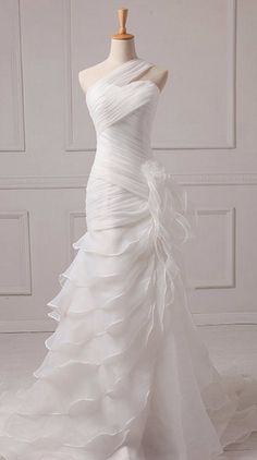 a white wedding dress on a mannequin