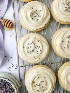 cookies with frosting and lavender sprinkles on a cooling rack