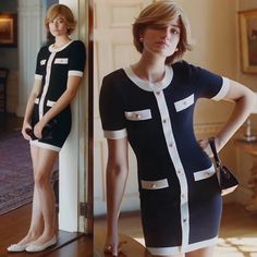 a woman standing in front of a mirror wearing a black and white dress with short sleeves