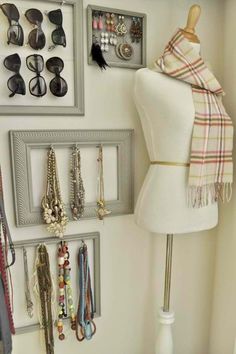 a white mannequin wearing a scarf and some earrings