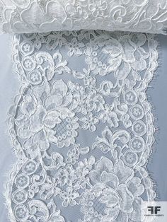 an image of white lace with flowers on it