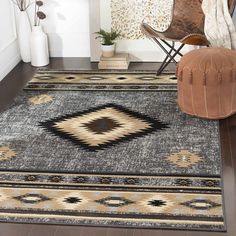 an area rug in the middle of a living room with a chair and vases