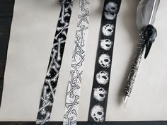 three different types of halloween ribbons on a piece of paper with a pen and ink