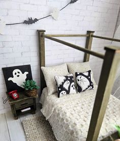 a bedroom with white brick walls and halloween decorations on the wall, along with a bed